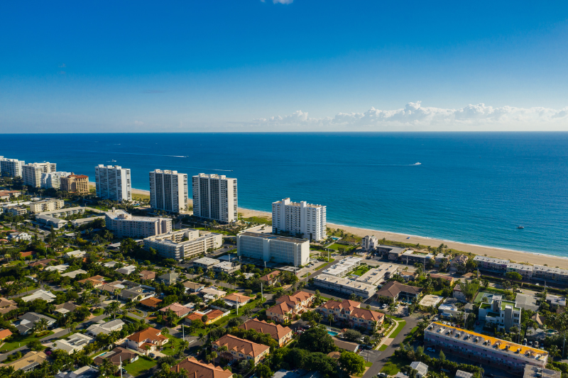 A picturesque Deerfield Beach neighborhood with beautiful homes and lush green surroundings.