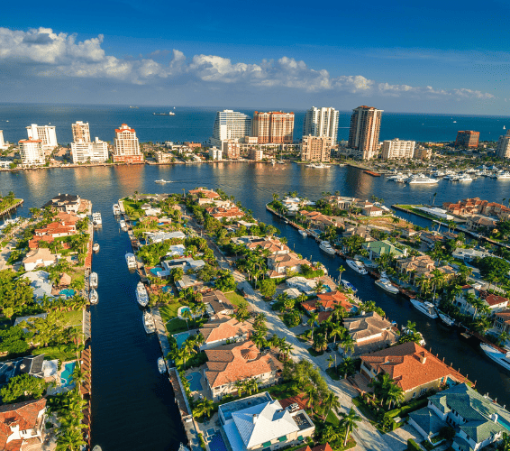 Elegant waterfront condos at the Atrium in Aventura, FL, surrounded by serene water views and lush landscaping.