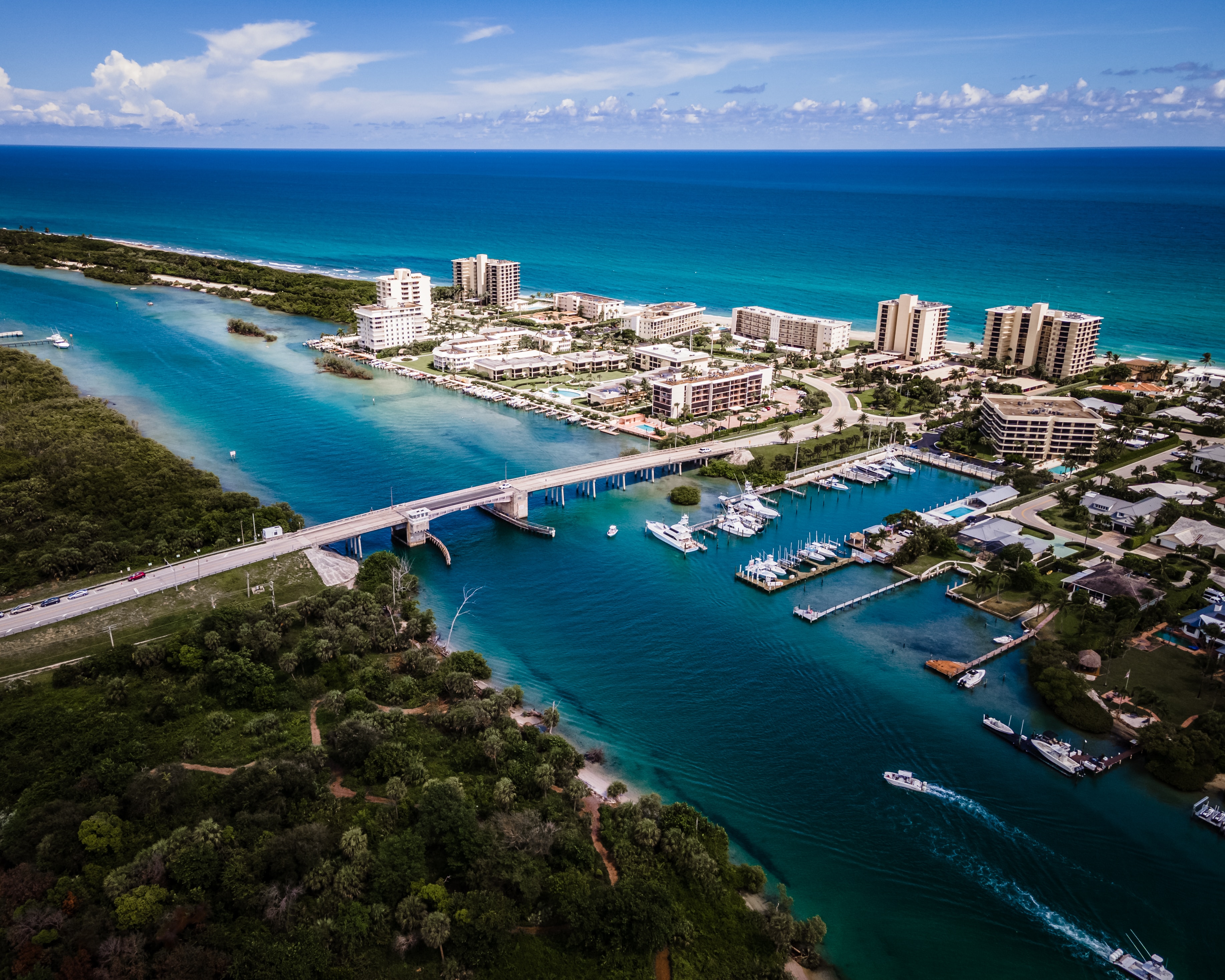 Aerial view of Key Biscayne showing clear blue waters, sandy beaches, and lush greenery.