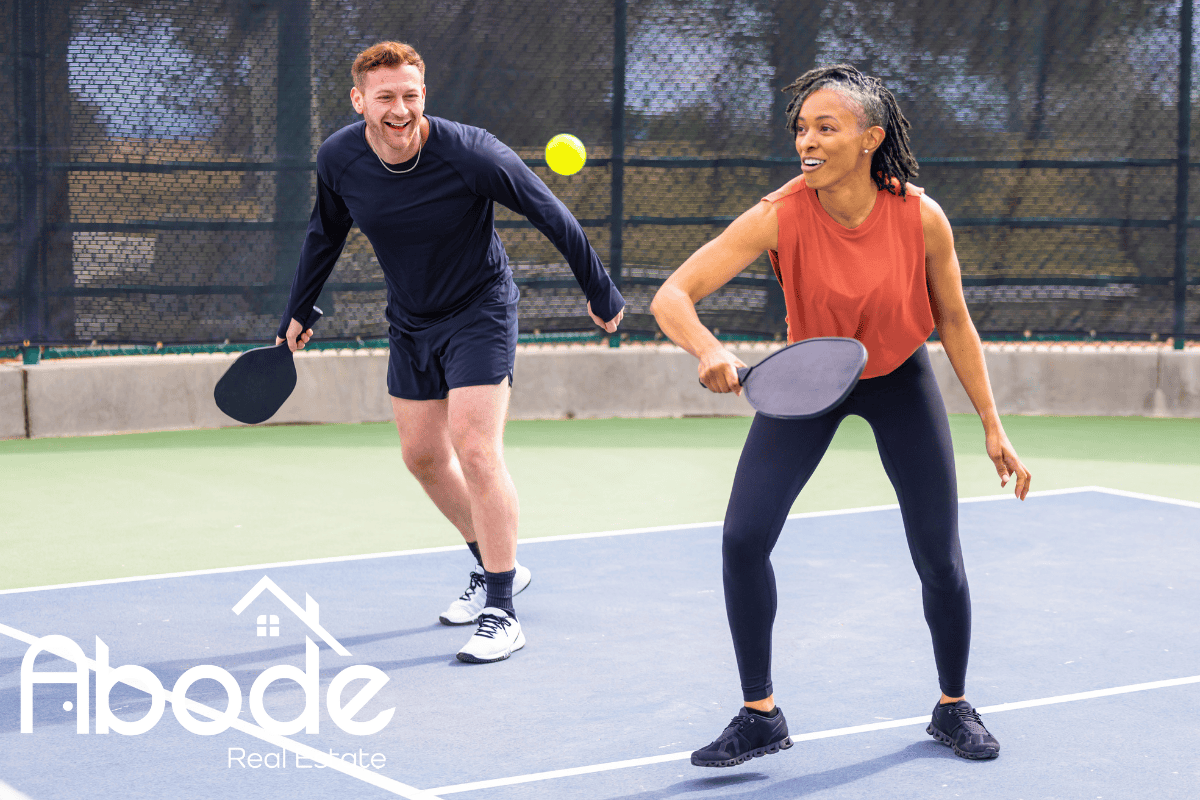 Action shot of pickleball players on a sunny Lauderdale By The Sea court.